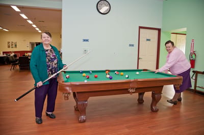 Residents playing pool in a communal area