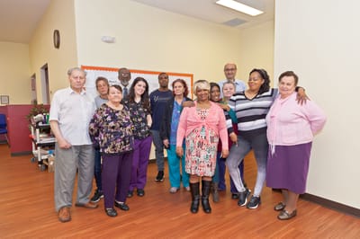 Residents and staff gathered in an activity room