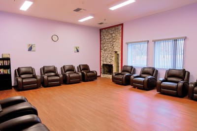Interior view of a cozy common area with recliners