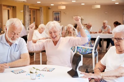 Residents enjoying a bingo game in a communal area
