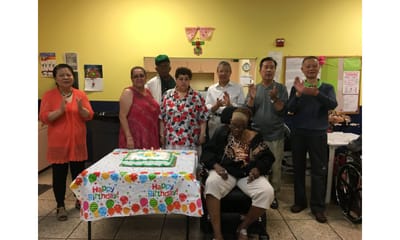 Residents celebrating a birthday party with a cake