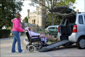 Rising Star Adult Day Care Center, Nursing Care in Ewing, NJ — Senior being assisted into a vehicle at a facility