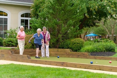 Residents enjoying a game outside in a lush garden