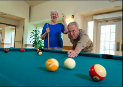 Residents enjoying a game of billiards in the activity room