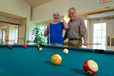 Residents playing billiards in a common area