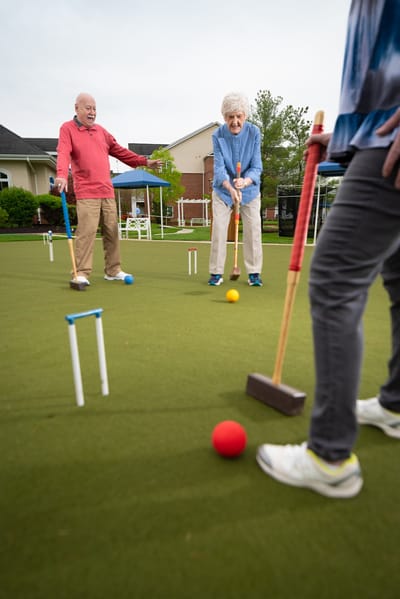 Residents enjoying a game of croquet outdoors