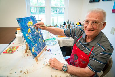 Resident painting during an art activity