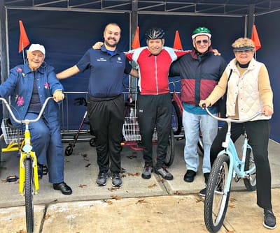 Residents and staff posing with bicycles