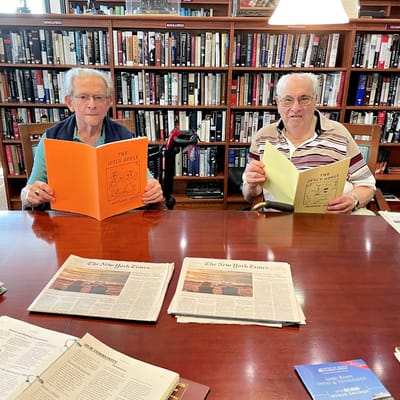 Two residents reading in a library