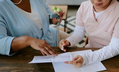 Caregiver assisting a resident with documentation