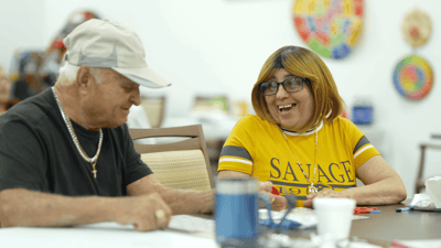 Residents enjoying a game at a social table