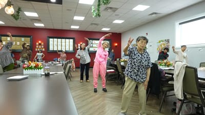 Residents participating in a group exercise activity in a common area