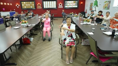 Residents participating in a seated exercise class