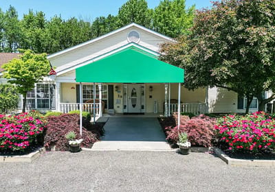 Exterior view of a senior care facility with landscaped entrance