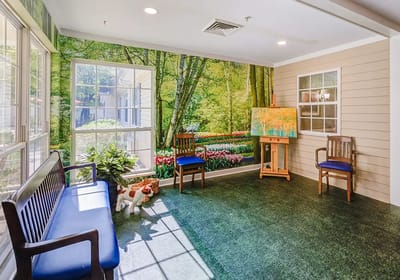Bright common area with floral mural and seating