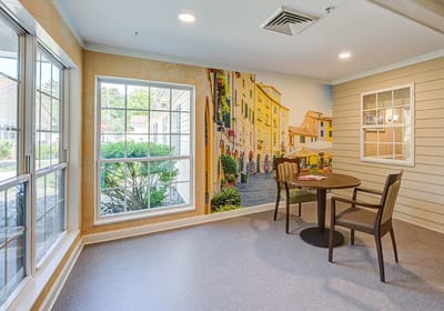 Common area with decorative mural and seating