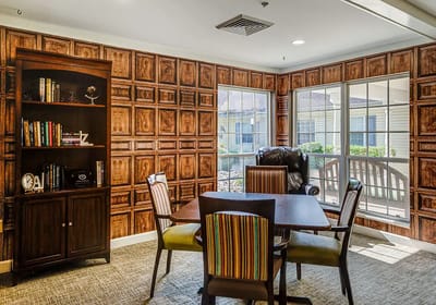 Cozy common area with bookshelves and large windows