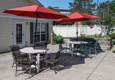 Outdoor seating area with red umbrellas and tables