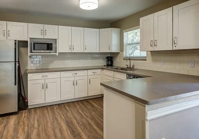Modern kitchen with white cabinetry and appliances