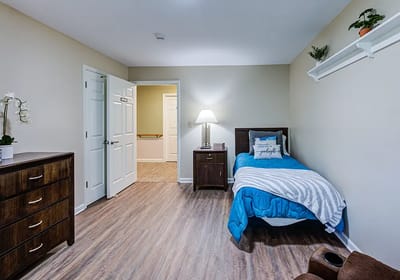 Cozy private bedroom with a bed and dresser
