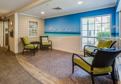 Bright common area with beach mural and seating