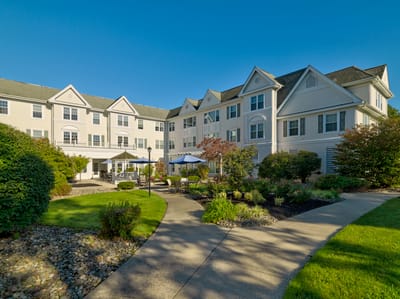 Exterior view of the assisted living facility with landscaped garden