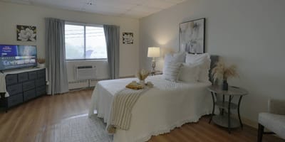 Cozy interior of a resident room with a bed and decor