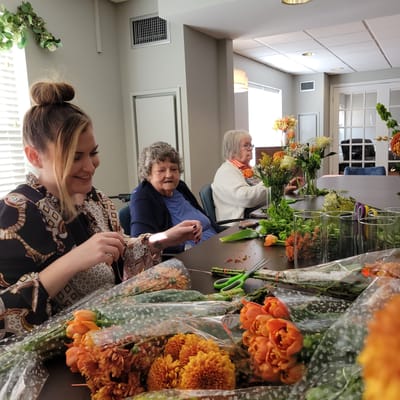 Residents and staff making flower arrangements