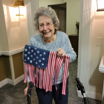 Resident celebrating with an American flag decoration