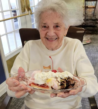 Resident enjoying a dessert in the activity room
