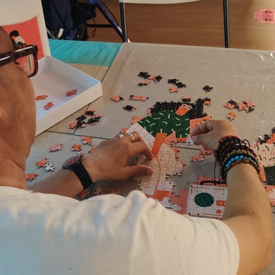 A resident working on a puzzle in an activity area