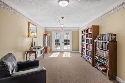 Bright interior common area with bookshelves and seating
