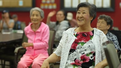 Seniors smiling and enjoying an activity in a common area