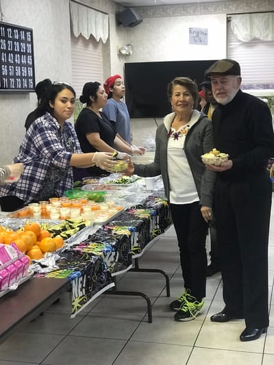 Residents enjoying a food distribution event in the common area