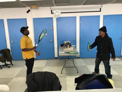 Residents engaging in an indoor activity with paddles