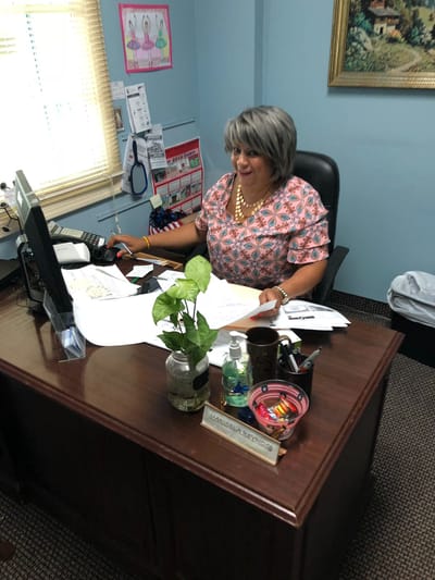 Staff member working at a desk in an office