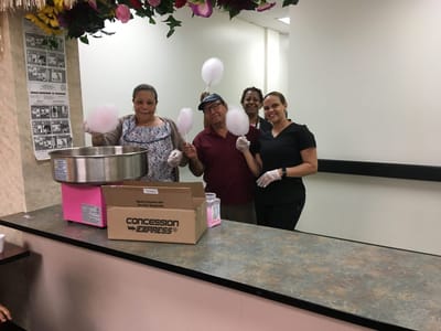 Residents and staff making cotton candy together