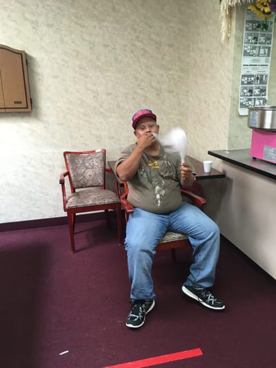 Resident enjoying cotton candy in a lounge area