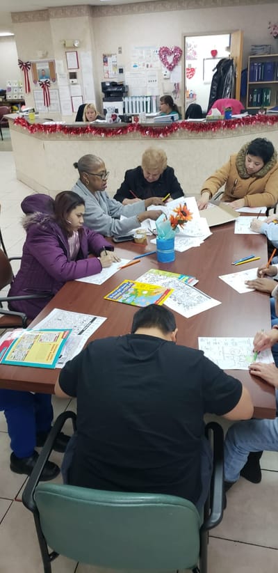 Residents and staff engaging in an art activity in a communal space