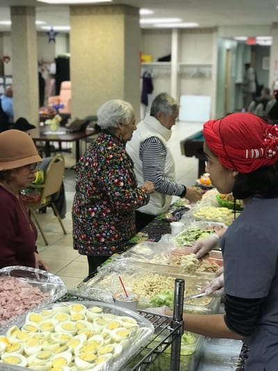Residents participating in a meal preparation activity