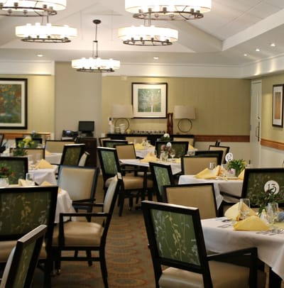 Dining room with elegantly set tables and floral centerpieces