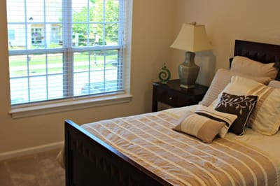 Cozy private room with a bed and lamp