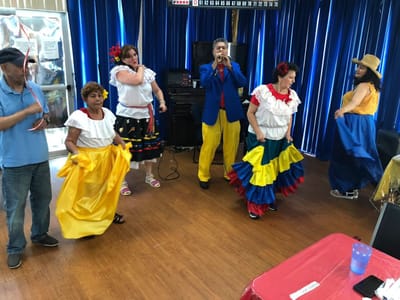 Residents participating in a colorful cultural dance event