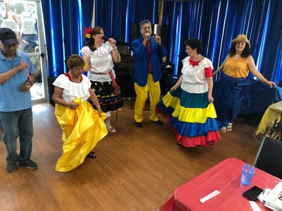Residents and staff engaging in a lively dance performance