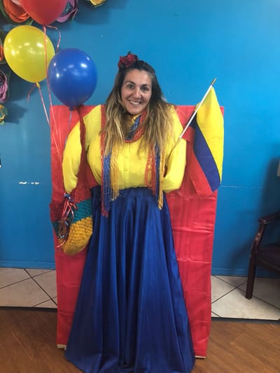 Staff member celebrating with balloons and decorations