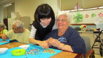 Staff assisting residents with craft activities