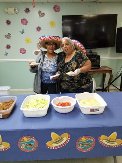 Residents celebrating with food at a festive gathering