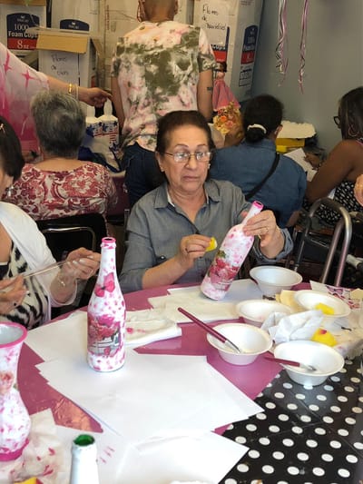 Residents participating in a craft activity inside a common area