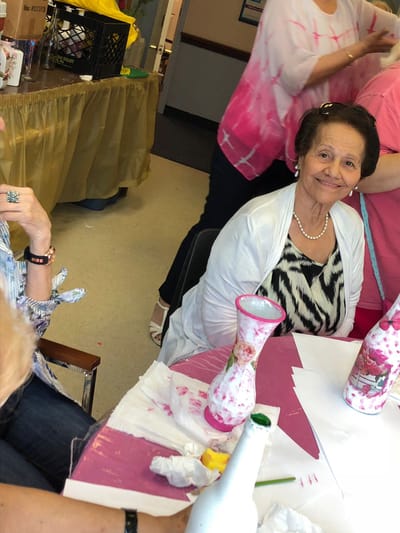 Residents enjoying an art activity at a table