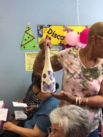 Resident showcasing a decorative piece during an activity